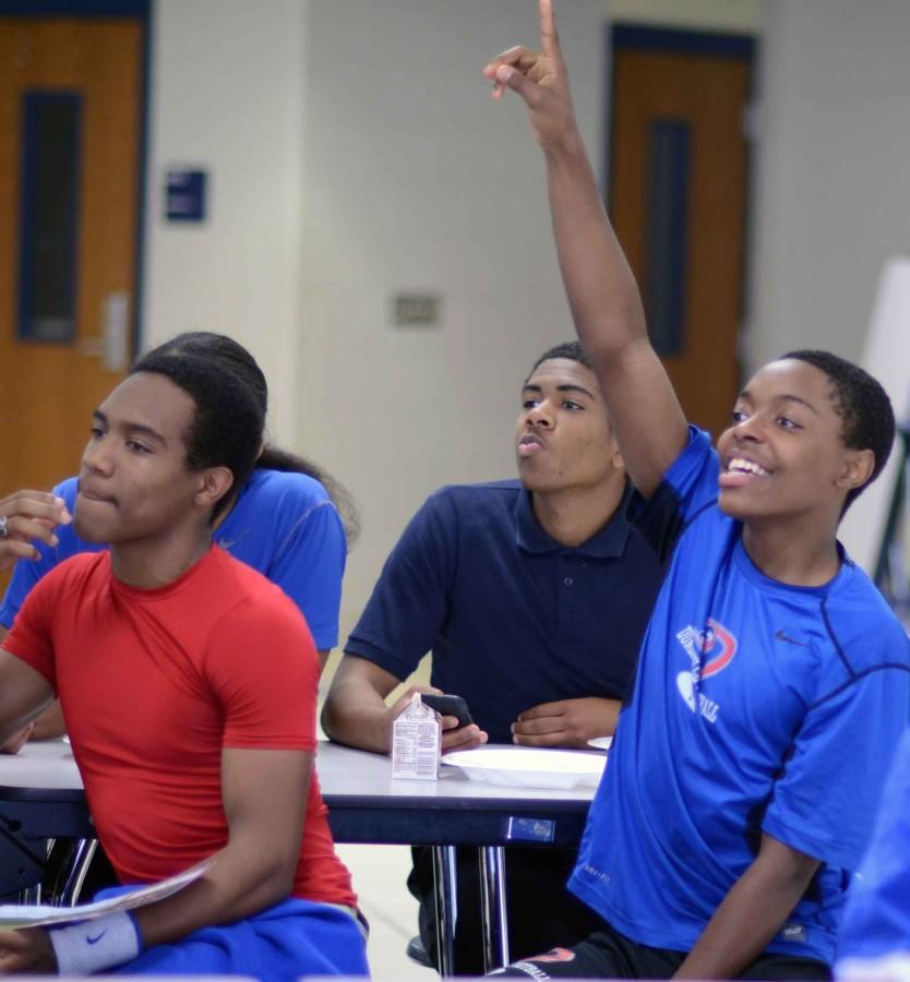 Athletes hurry to answer the questions in hopes of winnnig the prize during the Athletics Young Life Club. (Omar Orozco photo)