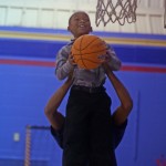 HOSA President Roderick Coleman helping a Hastings Elementary Husky to make a basket. (Bria Norman photo)