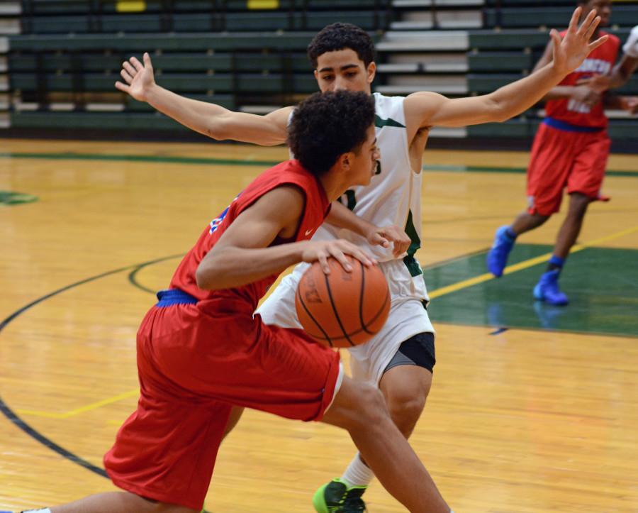 Senior Jalen Harris drives the ball in line against a Desoto defender in a previous season. (Photo by Olivia Davila)