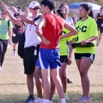 Coach Liesa Reed works with her runners at the first meet of the season.(Abigail Collins Photo)