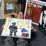 Mr. Gawedzinski poses underneath one of his former student's decorated tiles to display how he, too, feels like an Invisible Man. (Alisha Nichols photo)