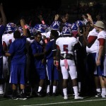 The players huddle up and go in for a high-five, releasing their must. (Tomica Charles photo)