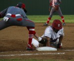 Duncanville player slides onto a base during the game against Cedar Hill. (Photo by Olivia Colchado)