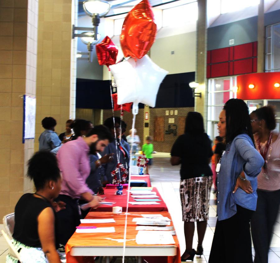 Parents talk to teachers for Meet the Teacher Night