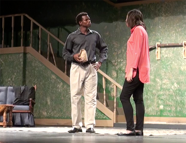 Two theatre students act out a scene of the happy-go-lucky play. 