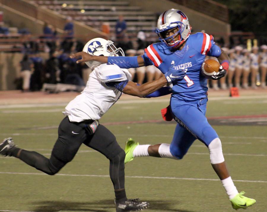 Senior Quarterback Mike Meyers pushes past a Midlothian defender during a hinge game in district play. (Alexis Rosebrock photo)