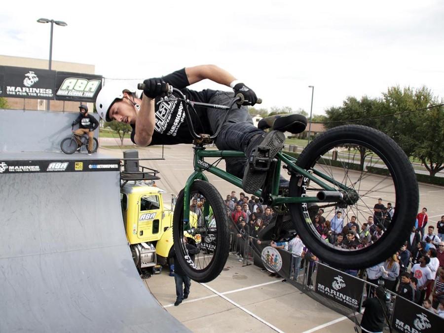 A biker takes a high jump over the top of a group of students at the Anti bullying rally sponsored by ASA Action Sports Tour and the Marine Corps. (Photo by Michelle Villegas)