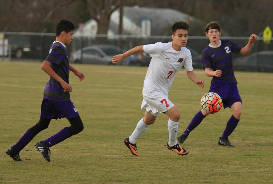 Senior James Labastida moves the ball between two Bonham defenders during the Panthers 5-0 win to open the Duncanville Classic. (Michelle Villegas photo)