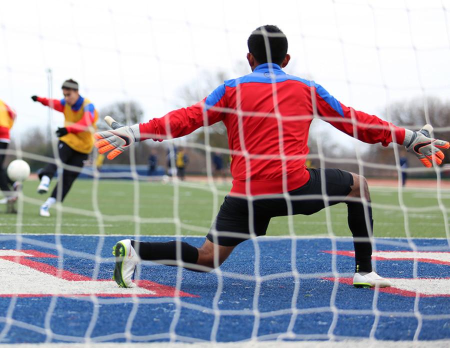 Senior Goalie Alexis Araiza works on his goal tending during warmups prior to the Jesuit matchup.  He allowed no goals during the gam.(Photo by Karla Estrada)