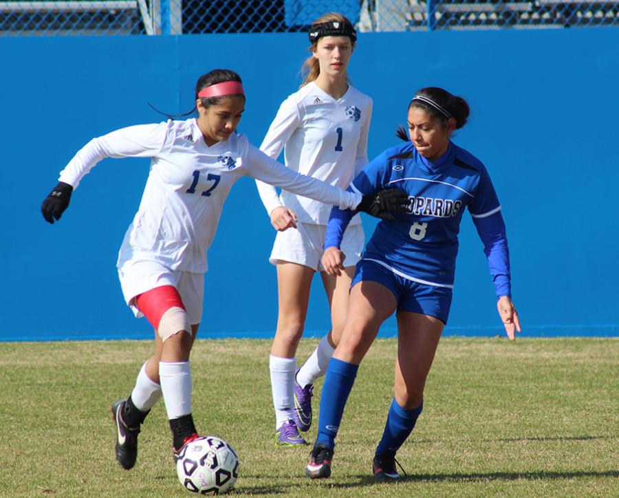 Miran Garza pushes the ball forward as Corine Daniels follows against a tough opponent in tournament play. (Ruth Thunderhawk photo)