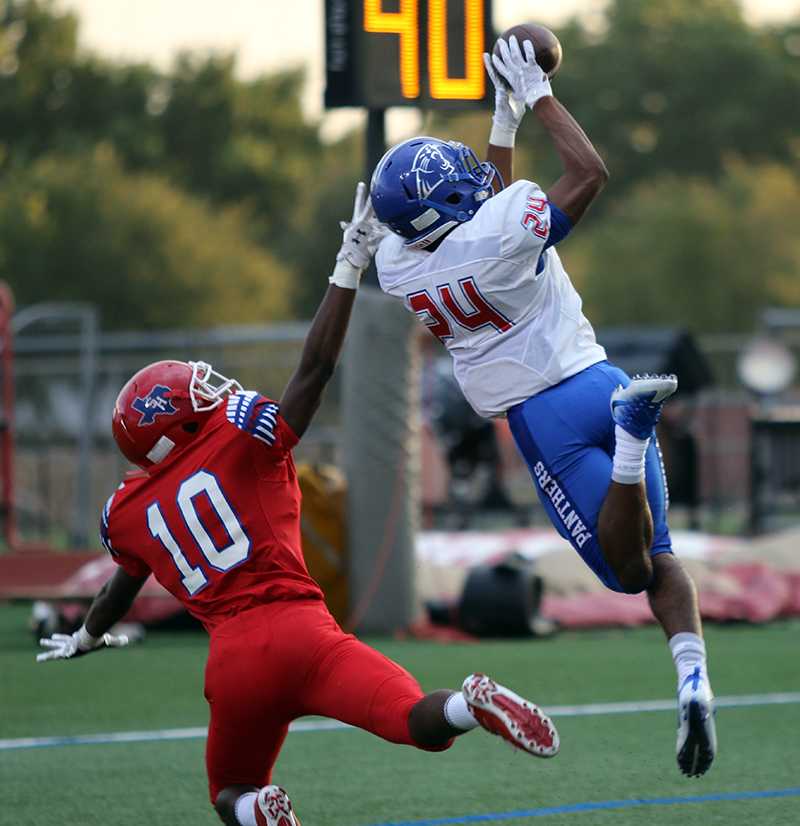 Sophomore cornerback Jalen Byrd goes up high looking for the interception in  a matchup with Arlington Sam Houston. (Photo by Emlyn Almanza)