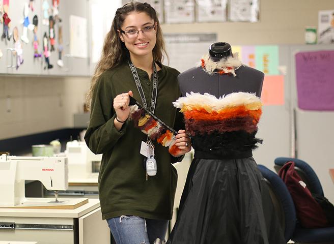 Maria Osegueda poses beside her garment. (Alina Ulloa Photo )