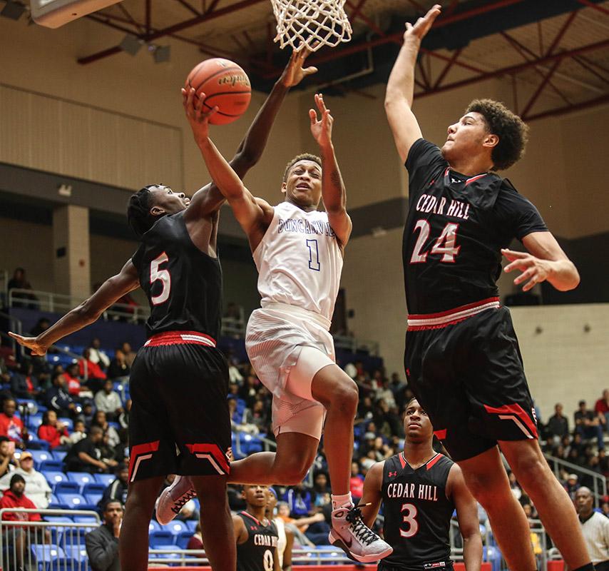 Senior Tyler Watkins splits two Cedar Hill defenders in a tough district loss. (Jose Sanchez photo)