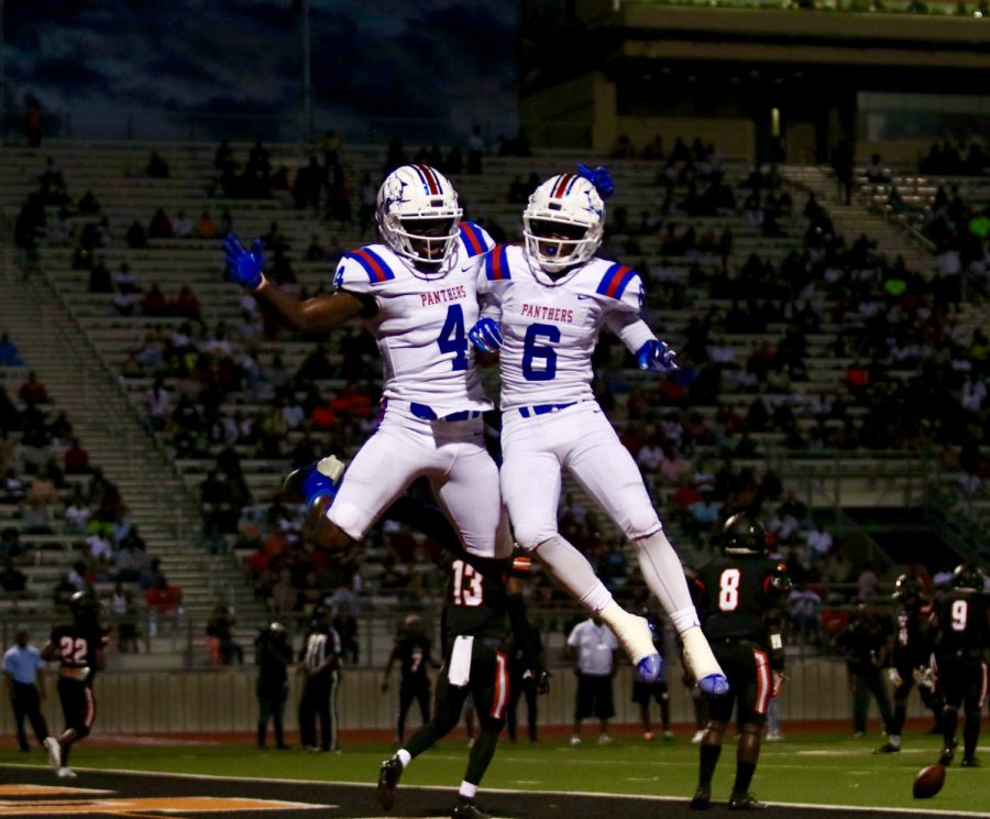 Zeriah Beason (4) celebrates with Marquelan Crowell (6) after a touchdown by Beason against the Lancaster Tigers.