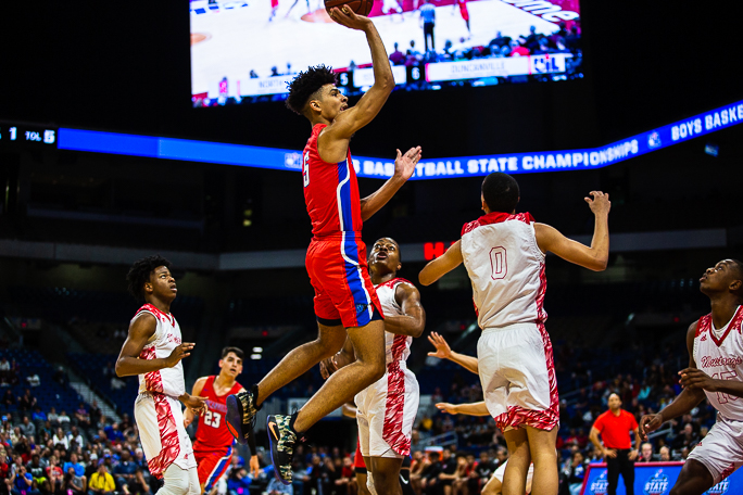 Junior Micah Peavy (5) goes up for a shot against North Shore in the basketball state semi final.