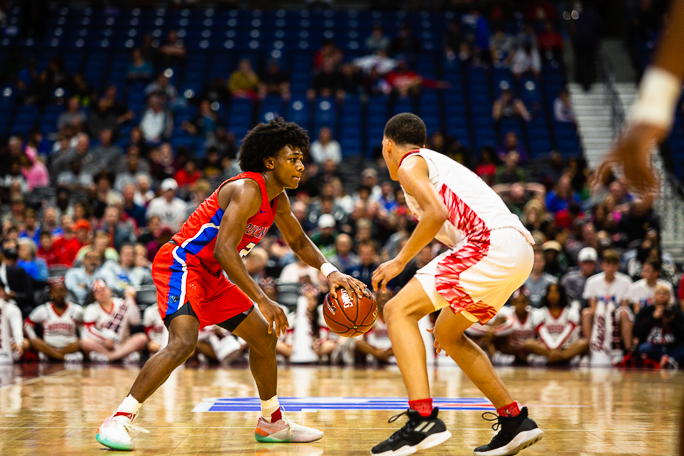 Junior Jabryant Hill (2) drives against the defense in the state semi final basketball game. 