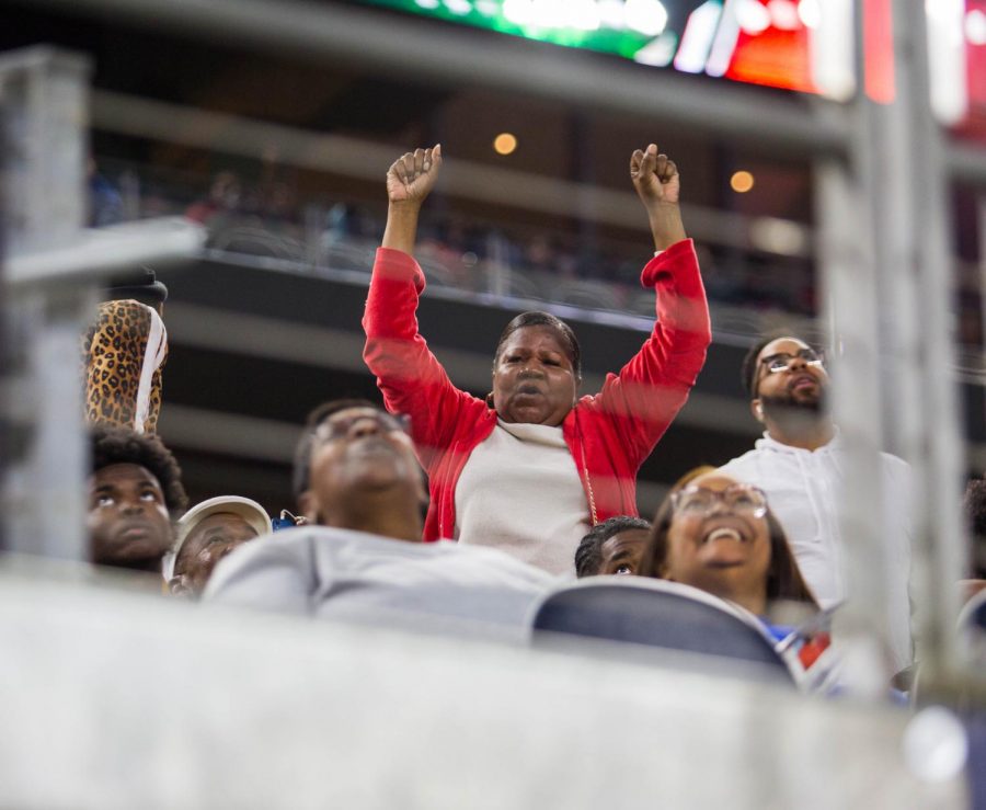 A fan celebrates after a touchdown against  Flower Mound