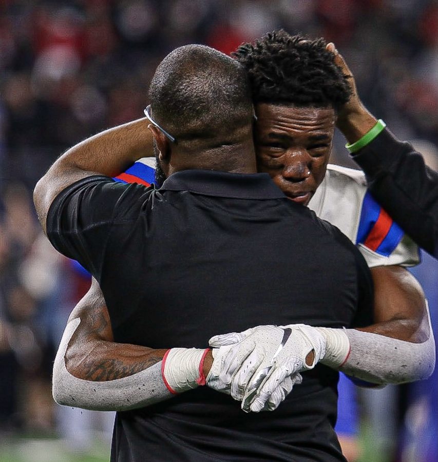 Coach Leon Paul hugs Marquelan Crowell after the game.