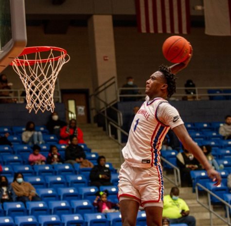 Ron Holland goes up for the slam against Midway during a district matchup