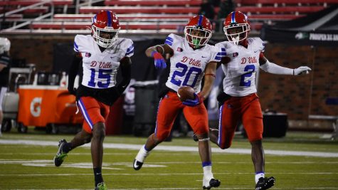 (20) Vernon Grant celebrates a fourth quarter interception with (15) Lamondrick Spencer and (2) Ka'davion Dotson Walker in the fourth quarter of their Region II final win against Prosper at SMU stadium in Dallas, TX.