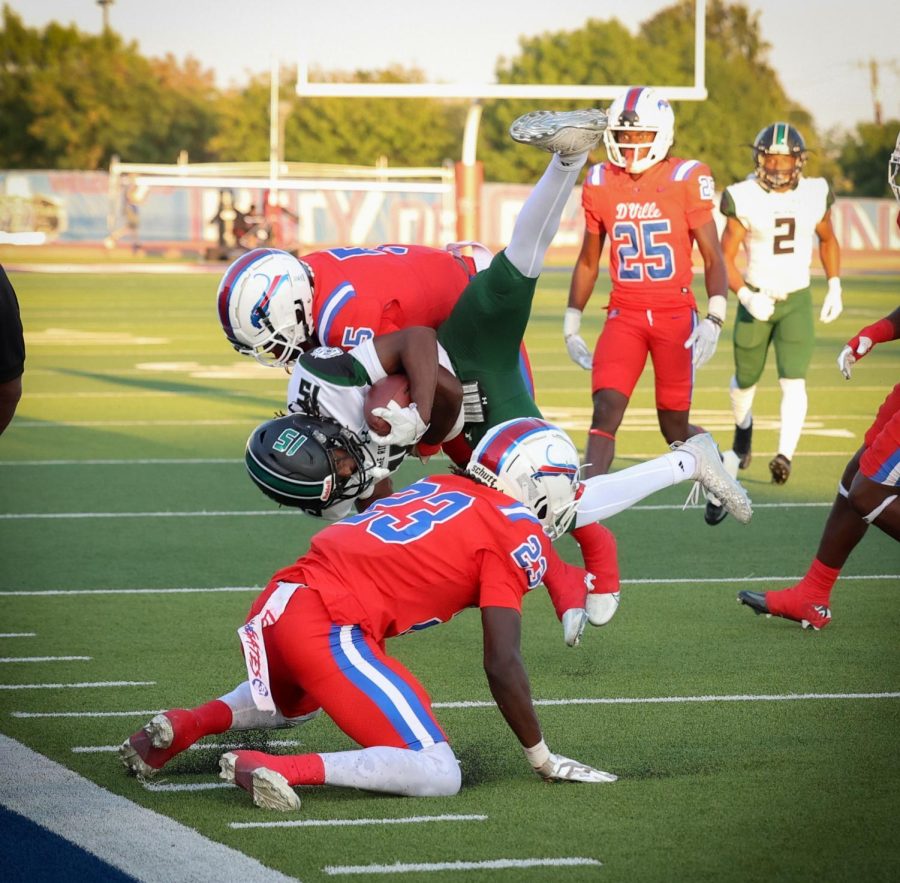 (5) Eli Wilson and (23) James Adams make the tackle against lake ridge.