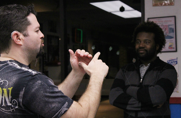 American Sign Language teacher Matthew Snelling speaks to a person in their language during a deaf chat event at Hav-R burgers in town. (Kennedy Stidham photo)