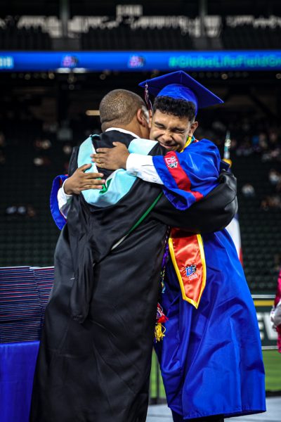 Senior Aiden Cortez hugs principal Bryan Byrd after crossing the stage at Globe Life field in Arlington, TX. 