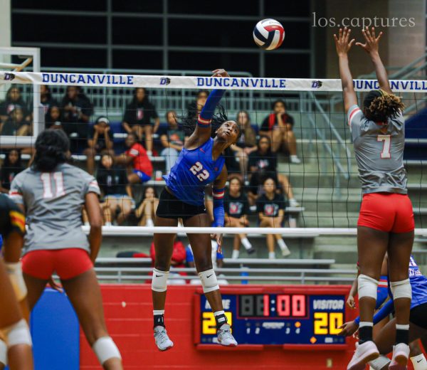 Freshman standout Payton Smith (22) spikes the ball during the match vs Cedar Hill at Sanda Meadows Arena.
